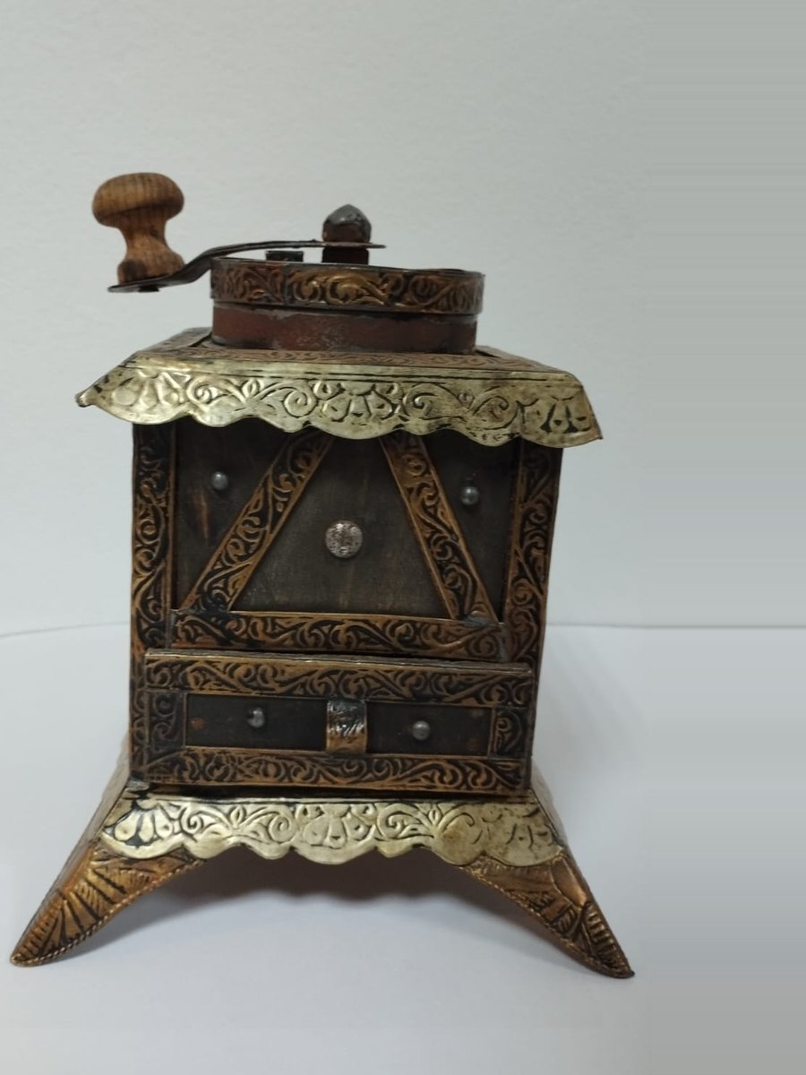 Engraved brass and copper Moroccan coffee grinder with a wooden crank handle